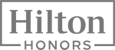 The image displays the Hilton Honors logo, featuring the text "Hilton" and "Honors" in a clean and modern font.