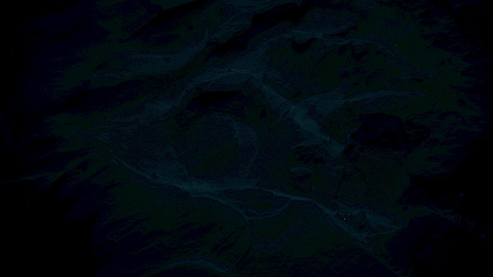 The image is very dark, making it difficult to discern details or objects clearly due to low visibility.